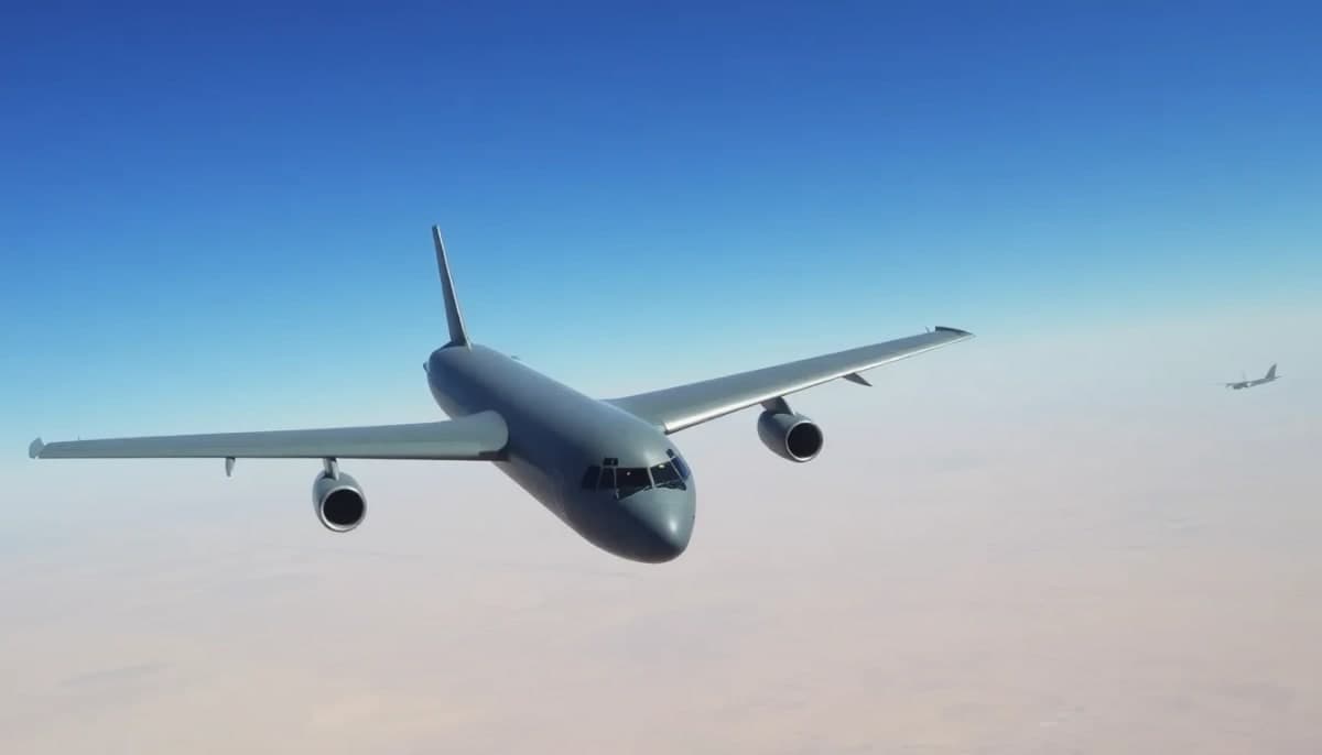 Military refueling plane flying over the Iraqi desert landscape.